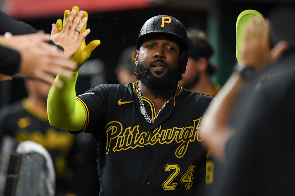 Pittsburgh Pirates' Marcell Ozuna celebrates in the dugout after scoring on a single by Henry Davis during the sixth inning of a baseball game against the Cincinnati Reds in Cincinnati, Saturday, Aug. 1, 2026. (AP Photo/Tanner Pearson)