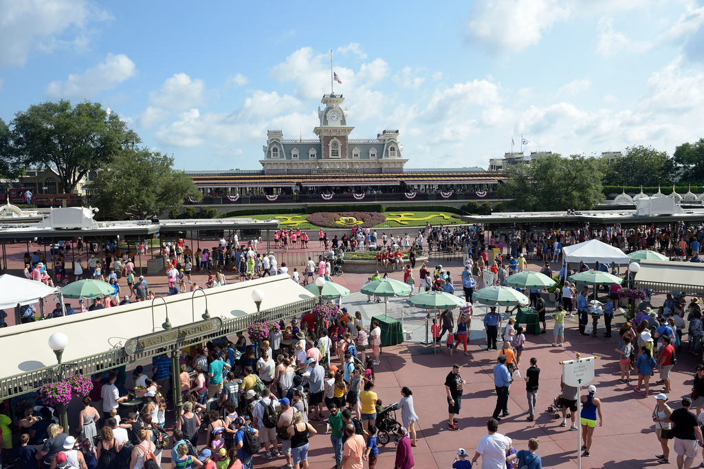 FILE - Guests arrive at Disney's Magic Kingdom theme park in Lake Buena Vista, Fla., June 15, 2016. (AP Photo/Phelan M. Ebenhack, File)