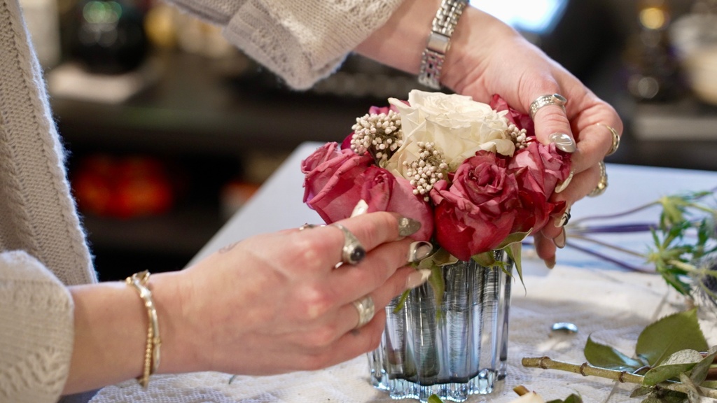 Megan Feller arranges bouquets for a Halloween party at her apartment in Edina, Minn. on Saturday, Oct. 25, 2025. (AP Photo/Mark Vancleave)