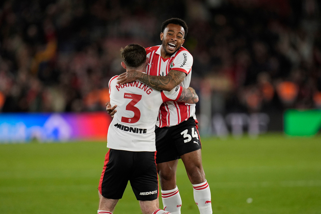 Southampton's Welington, right, and Ryan Manning celebrate at the final whistle in the EFL Championship play off semifinal soccer game between Southampton and Middlesbrough, Tuesday, May 12, 2026, in, Southampton, England. (Andrew Matthews/PA via AP)