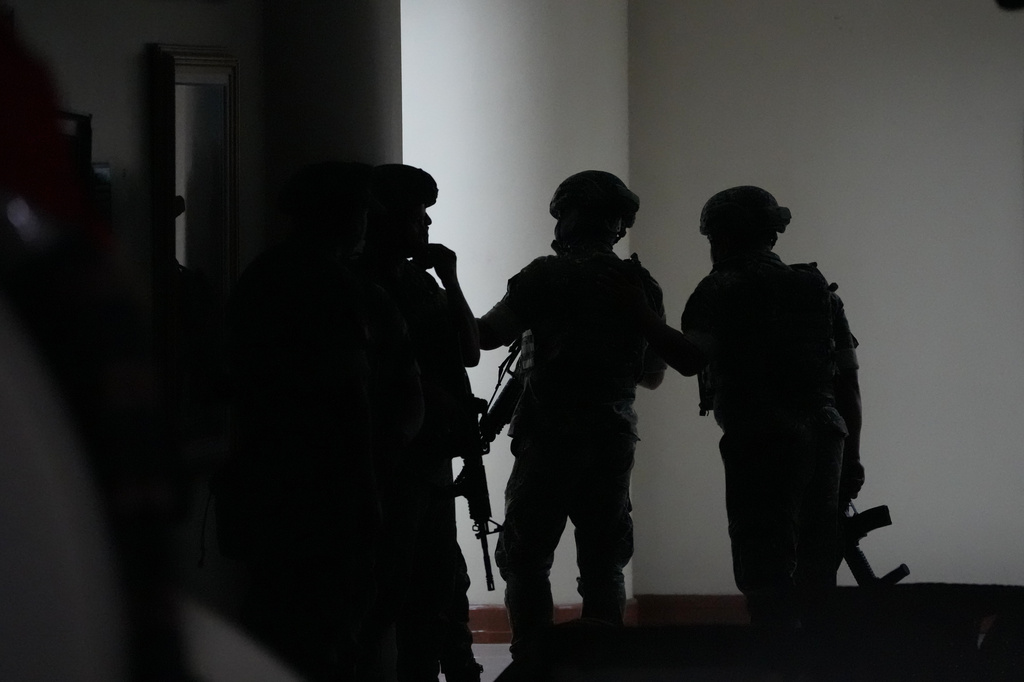 Philippine troopers exchange fire along a hallway at the Philippine Senate in Pasay, Philippines on Wednesday May 13, 2026. (AP Photo/Aaron Favila)