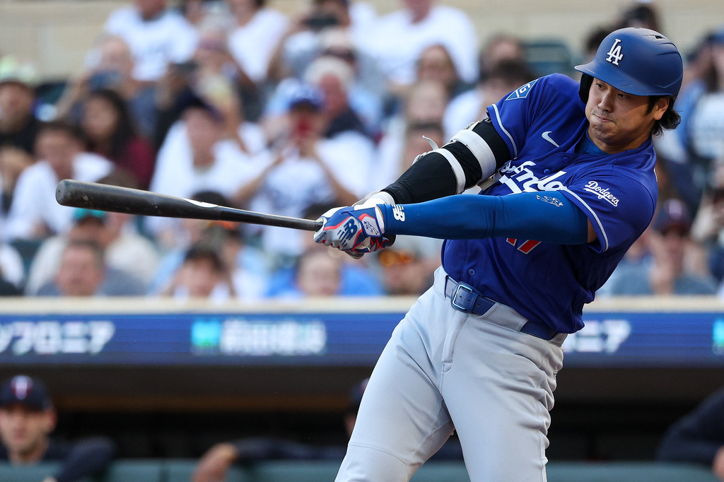 Los Angeles Dodgers designated hitter Shohei Ohtani hits a solo home run against the Minnesota Twins during the first inning of a baseball game, Monday, June 22, 2026, in Minneapolis. (AP Photo/Matt Krohn)