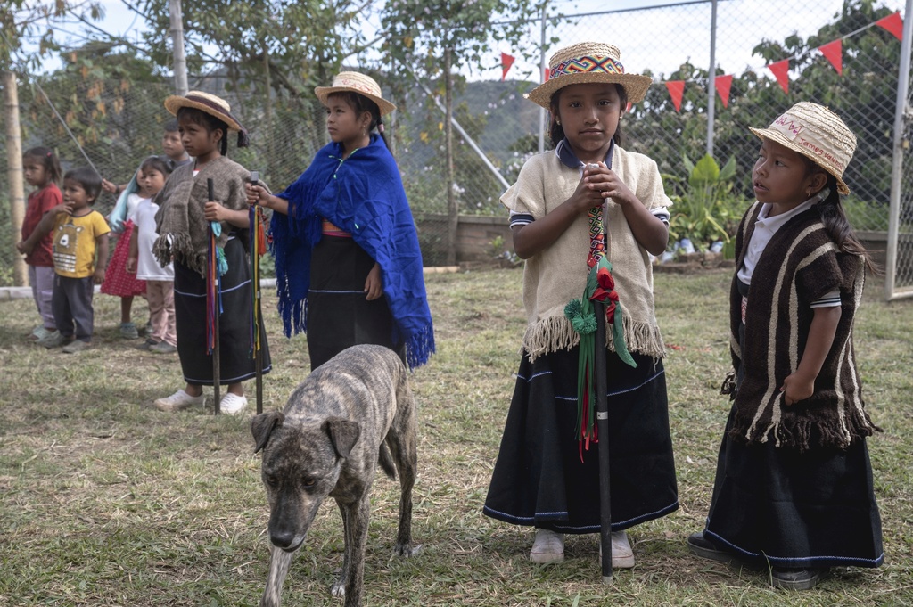 Young dancers, in traditional Indigenous clothes, wait for a graduation ceremony to begin at a school on July 18, 2025, in Manuelico village, Caldono, Colombia. (AP Photo/Nadège Mazars)