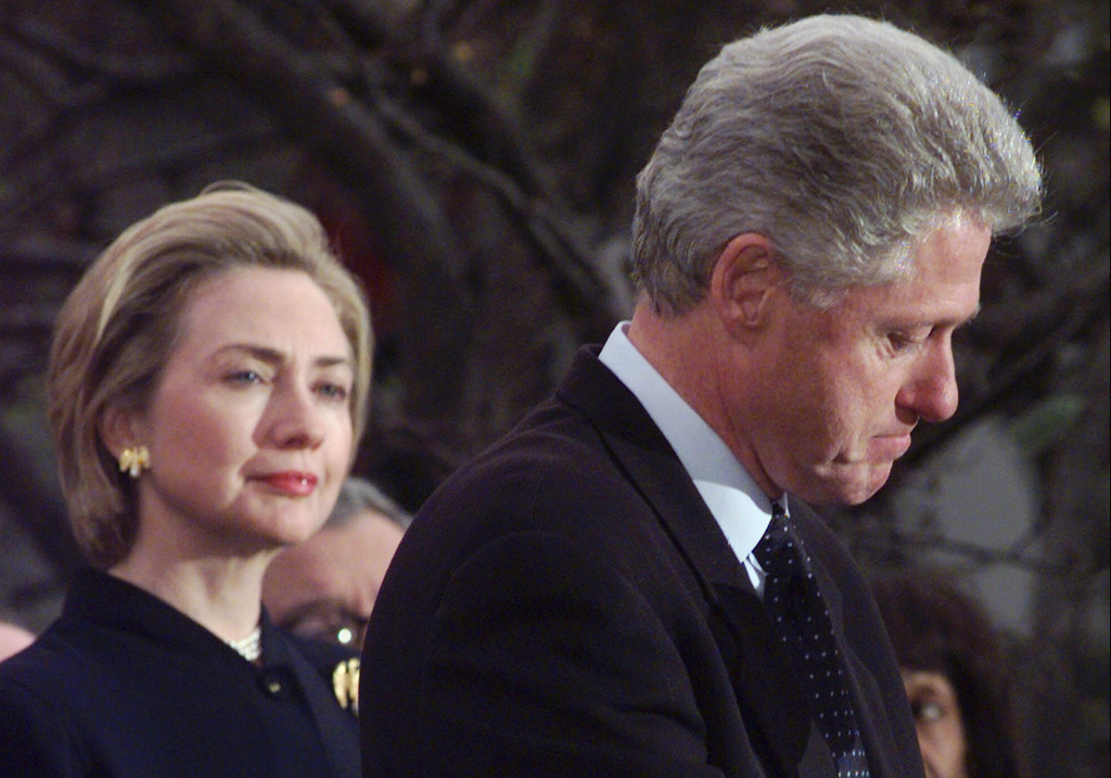 FILE - President Clinton makes a statement as first lady Hillary Clinton looks on at the White House, Dec. 19, 1998 in Washington. (AP Photo/Susan Walsh, file)