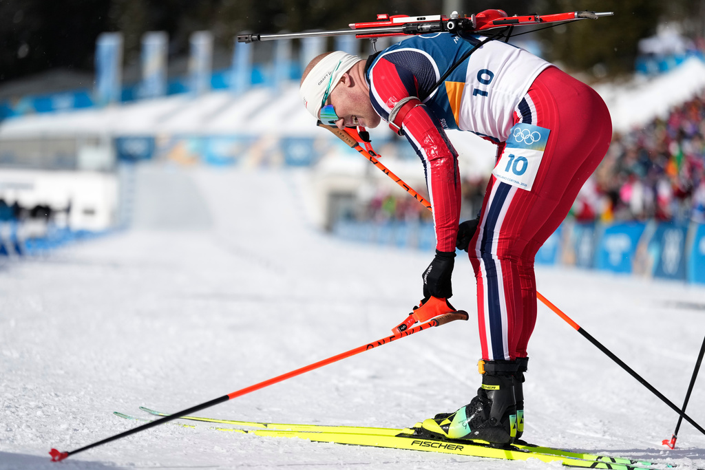 Johannes Dale-Skjevdal, of Norway, reacts in the finish area of the men's 15-kilometer mass start biathlon race after winning gold at the 2026 Winter Olympics in Anterselva, Italy, Friday, Feb. 20, 2026. (AP Photo/Mosa'ab Elshamy)