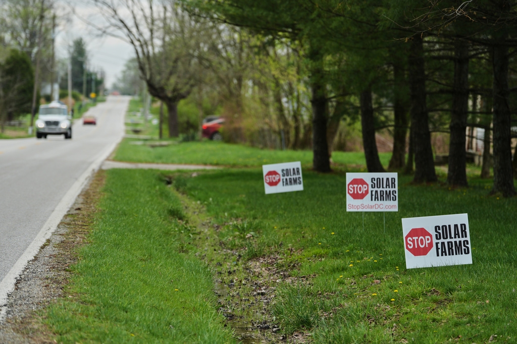 Signs opposing solar development sit near a road Friday, April 3, 2026, in Manchester, Ind. (AP Photo/Joshua A. Bickel)