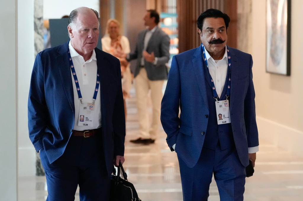 Mark Lamping, left, president of the Jacksonville Jaguars. and team owner Shahid Khan arrive at the NFL football owners' meetings Tuesday, May 19, 2026, in Orlando, Fla. (AP Photo/John Raoux)