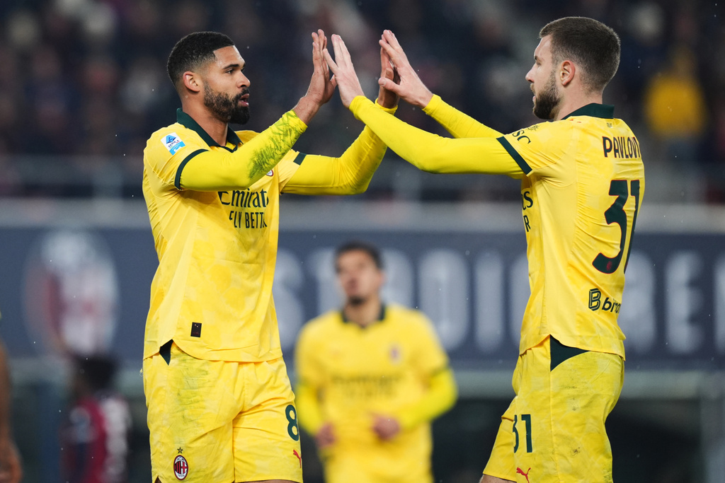 AC Milan's Ruben Loftus-Cheek, left, celebrates with Strahinja Pavlovic after scoring a goal during the Serie A soccer match between Bologna and Milan in Bologna, Italy, Tuesday Feb. 3, 2026. (Massimo Paolone/LaPresse via AP)
