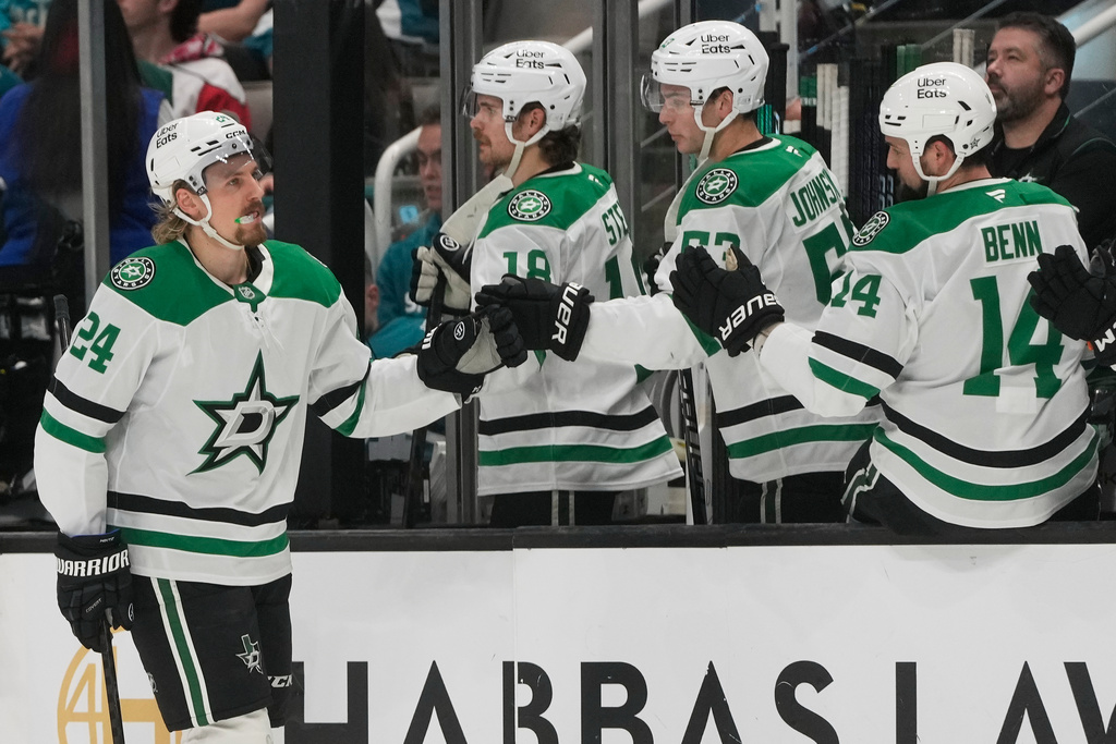 Dallas Stars center Roope Hintz (24) is congratulated by teammates after scoring against the San Jose Sharks during the first period of an NHL hockey game in San Jose, Calif., Thursday, Dec. 18, 2025. (AP Photo/Jeff Chiu)