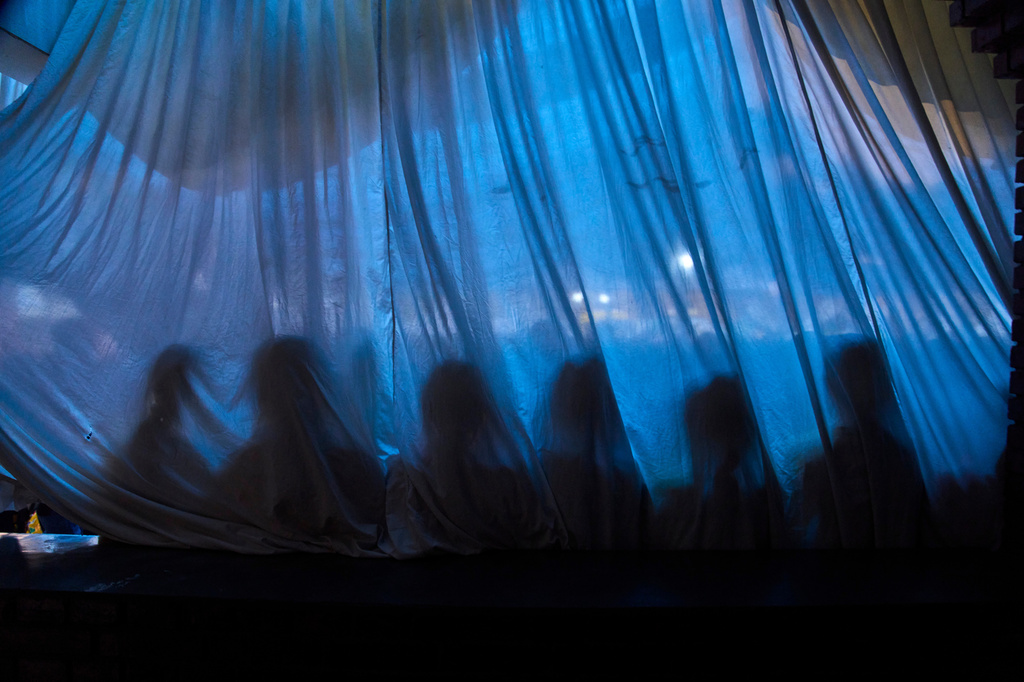 The shadows of Tibetan children are cast on a curtain as they wait to perform in a cultural program celebrating the 91st birthday of the Dalai Lama in Kathmandu, Nepal, Monday, July 6, 2026. (AP Photo/Niranjan Shrestha)