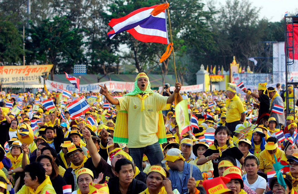 FILE - Thai protesters wave flags and cheer during a rally opposing Prime Minister Thaksin Shinawatra at the Royal Plaza in Bangkok, Thailand, on Feb. 4, 2006. (AP Photo/Sakchai Lalit, File)