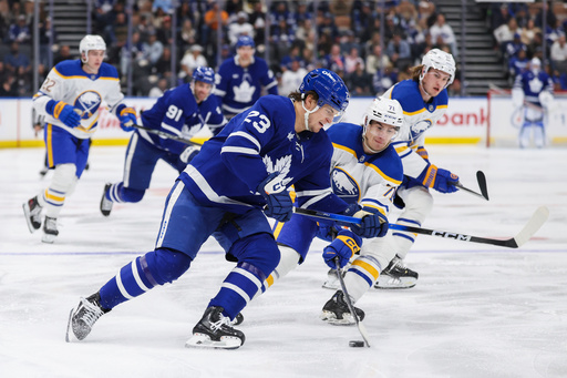 Buffalo Sabres' Ryan McLeod (71) takes the puck from Toronto Maple Leafs' Matthew Knies (23) during second period NHL hockey action in Toronto, Saturday, Oct. 25, 2025. (Nick Iwanyshyn/The Canadian Press via AP) Buffalo Sabres' Ryan McLeod (71) takes the puck from Toronto Maple Leafs' Matthew Knies (23) during second period NHL hockey action in Toronto, Saturday, Oct. 25, 2025. (Nick Iwanyshyn/The Canadian Press via AP)