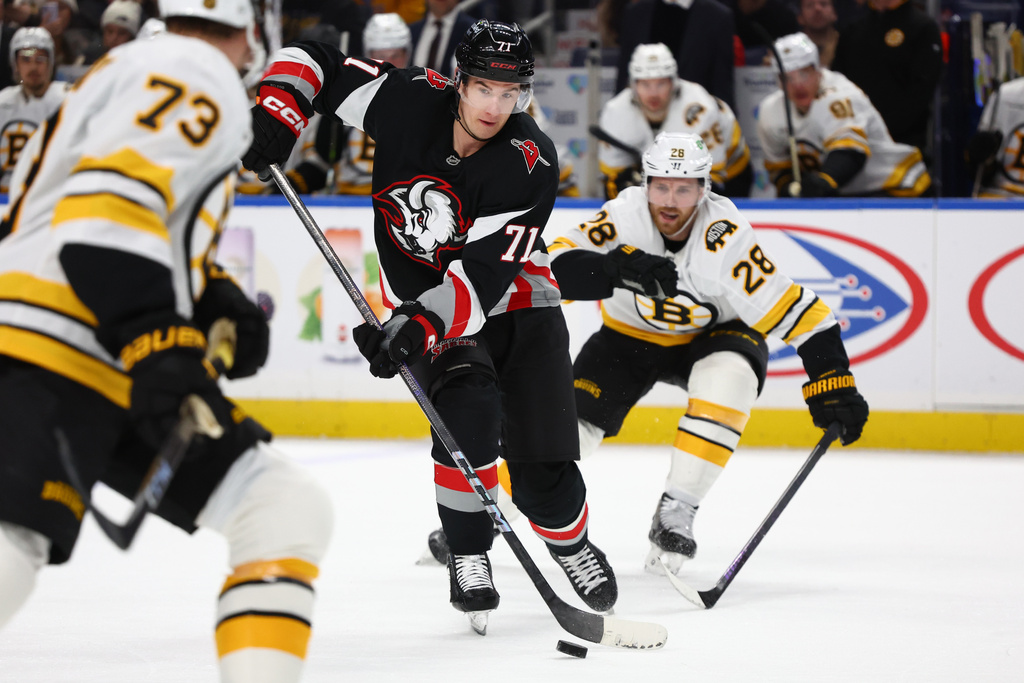 Buffalo Sabres center Ryan McLeod (71) is pressured by Boston Bruins center Elias Lindholm (28) during the first period of an NHL hockey game Saturday, Dec. 27, 2025, in Buffalo, N.Y. (AP Photo/Jeffrey T. Barnes)