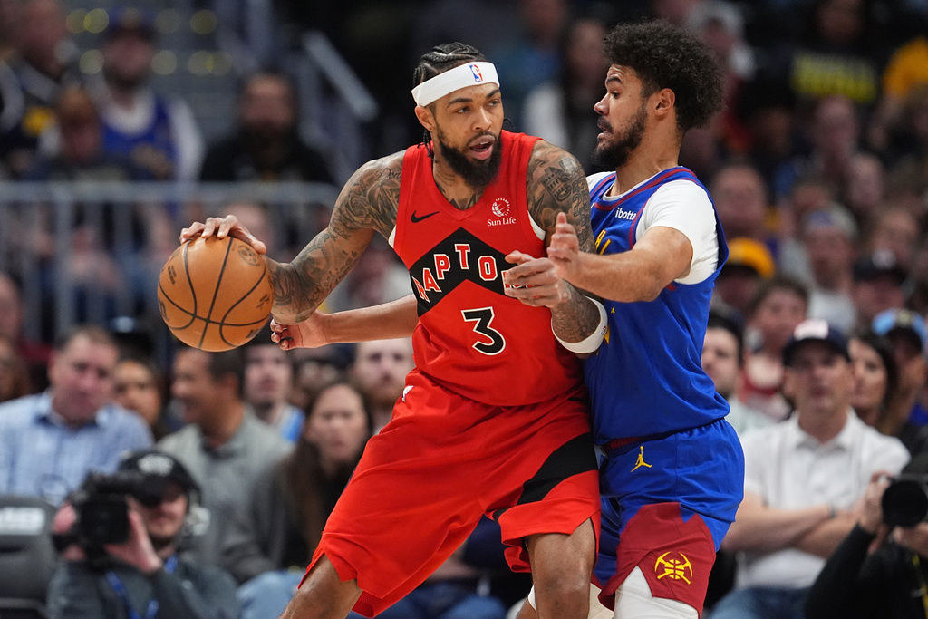 Toronto Raptors forward Brandon Ingram, left, works against Denver Nuggets forward Cameron Johnson in the first half of an NBA basketball game Friday, March 20, 2026, in Denver. (AP Photo/David Zalubowski)
