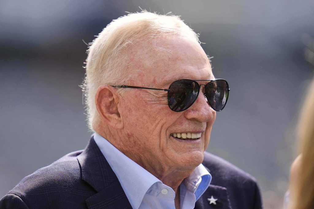 Dallas Cowboys team owner Jerry Jones talks with others while watching warmups before an NFL football game against the Chicago Bears Sunday, Sept. 21, 2025, in Chicago. (AP Photo/Erin Hooley)