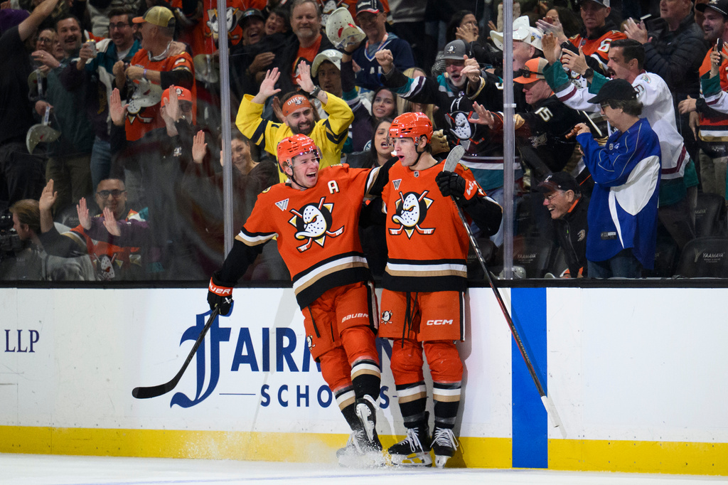 Anaheim Ducks right wing Beckett Sennecke, right, celebrates his goal with defenseman Jackson LaCombe during the first period of an NHL hockey game against the Calgary Flames, Tuesday, Oct. 13, 2026, in Anaheim, Calif. (AP Photo/Kyusung Gong)