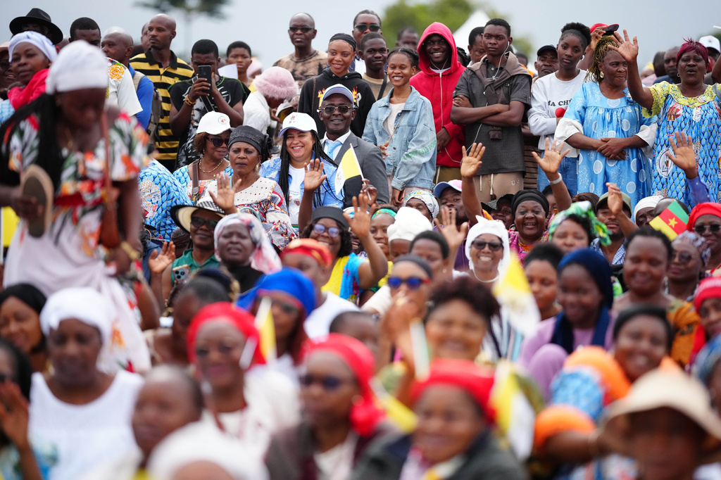 People wait for Pope Leo XIV at Yaounde Ville Airport, Cameroon, Saturday, April 18, 2026 on the sixth day of his 11-day pastoral visit to Africa. (AP Photo/Andrew Medichini)