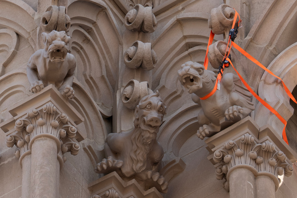 The final new terra cotta gargoyle is secured at right after being installed high on the Cathedral Basilica of the Assumption, known as "America's Notre Dame," in Covington, Ky., on Monday, March 30, 2026. (AP Photo/Carolyn Kaster)
