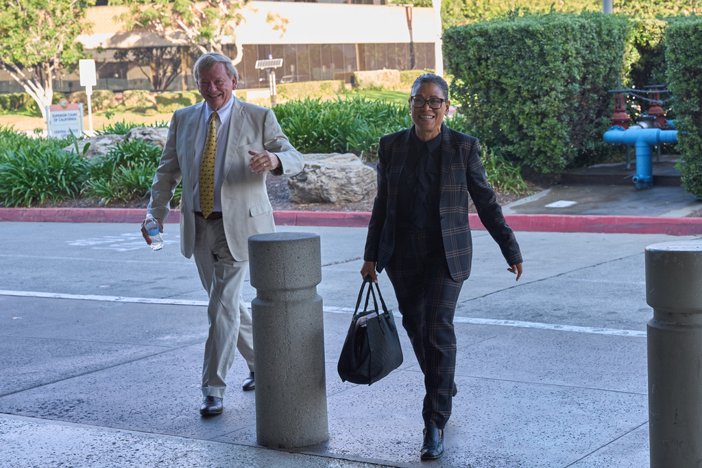 Shawn Holley, right, and Rusty Hardin, attorneys for the family of former baseball pitcher Tyler Skaggs, arrive during the trial for the wrongful death lawsuit accusing the Los Angeles Angels baseball team of being responsible for the 2019 drug overdose death of Skaggs Tuesday, Oct. 21, 2025, in Santa Ana, Calif. (AP Photo/Gregory Bull)