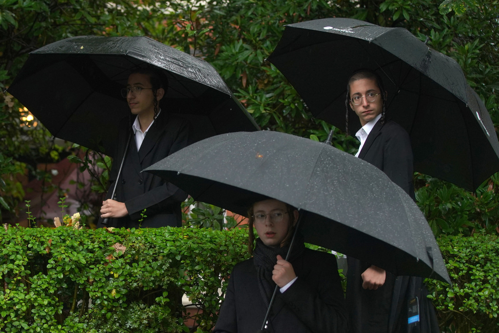 Young Jewish men attend a vigil for the victims of the attack on at Heaton Park Hebrew Congregation synagogue, in Crumpsall, Manchester, England, Friday, Oct. 3, 2025. (AP Photo/Ian Hodgson)