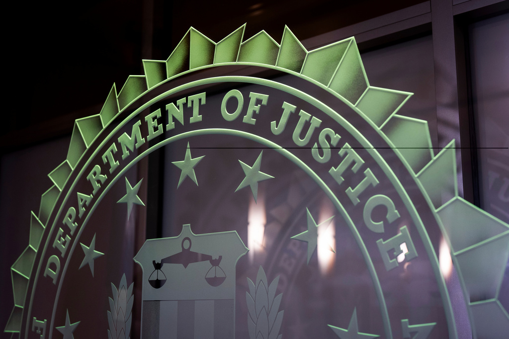 FILE - A sign reading Department of Justice is displayed at the FBI field office, in Portland, Ore., Jan. 16, 2025. (AP Photo/Jenny Kane, File)