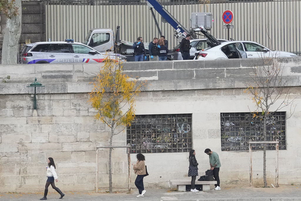 Police officers work by a basket lift used by thieves at the Louvre museum after a robbery Sunday, Oct. 19, 2025 in Paris. (AP Photo/Thibault Camus)