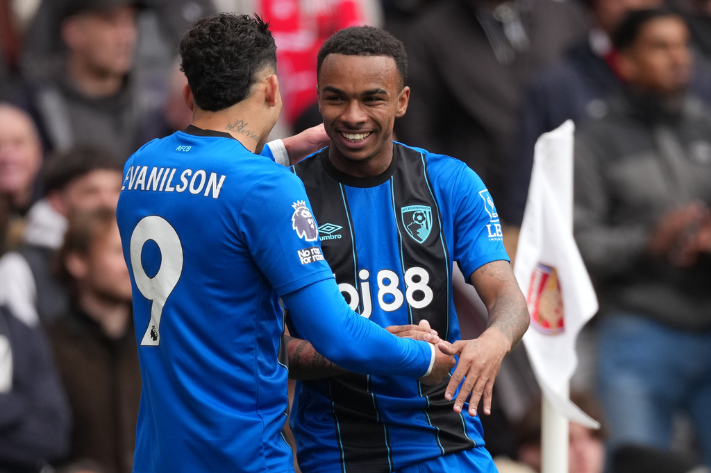 Bournemouth's Evanilson, and Eli Junior Kroupi celebrate after scoring during the Premier League soccer match between Arsenal and Bournemouth in London, England Saturday, April 11, 2026. (AP Photo/Dave Shopland)