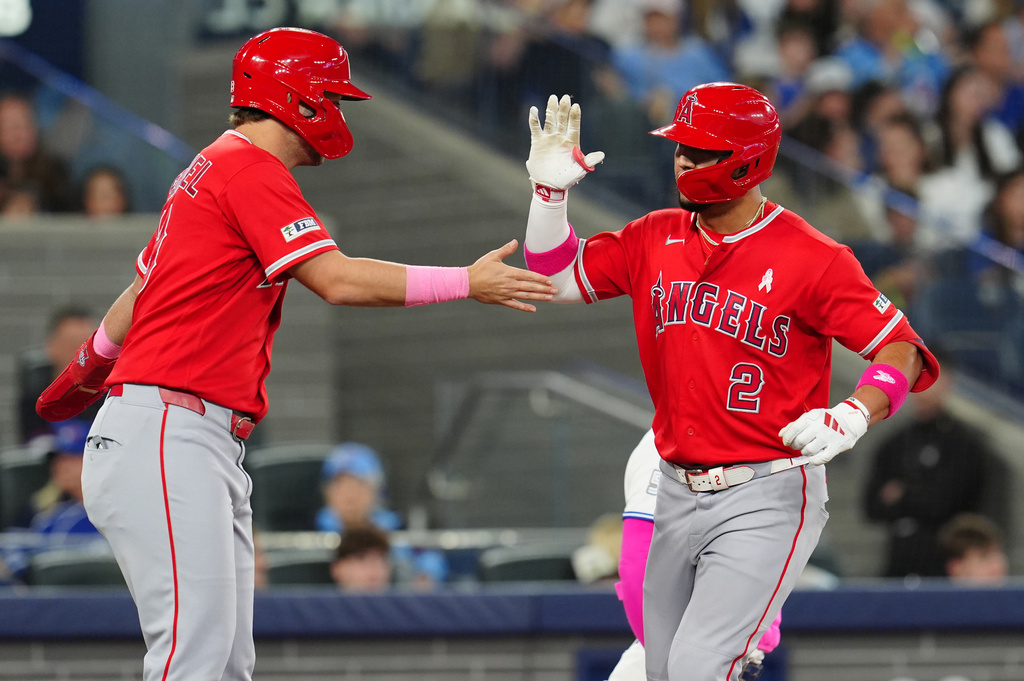 Los Angeles Angels' Nolan Schanuel, left, congratulates Oswald Peraza (2) after Peraza hit a two-run home run during the top of the fifth inning of a baseball game against the Toronto Blue Jays in Toronto, Sunday, May 10, 2026. (Frank Gunn/The Canadian Press via AP)