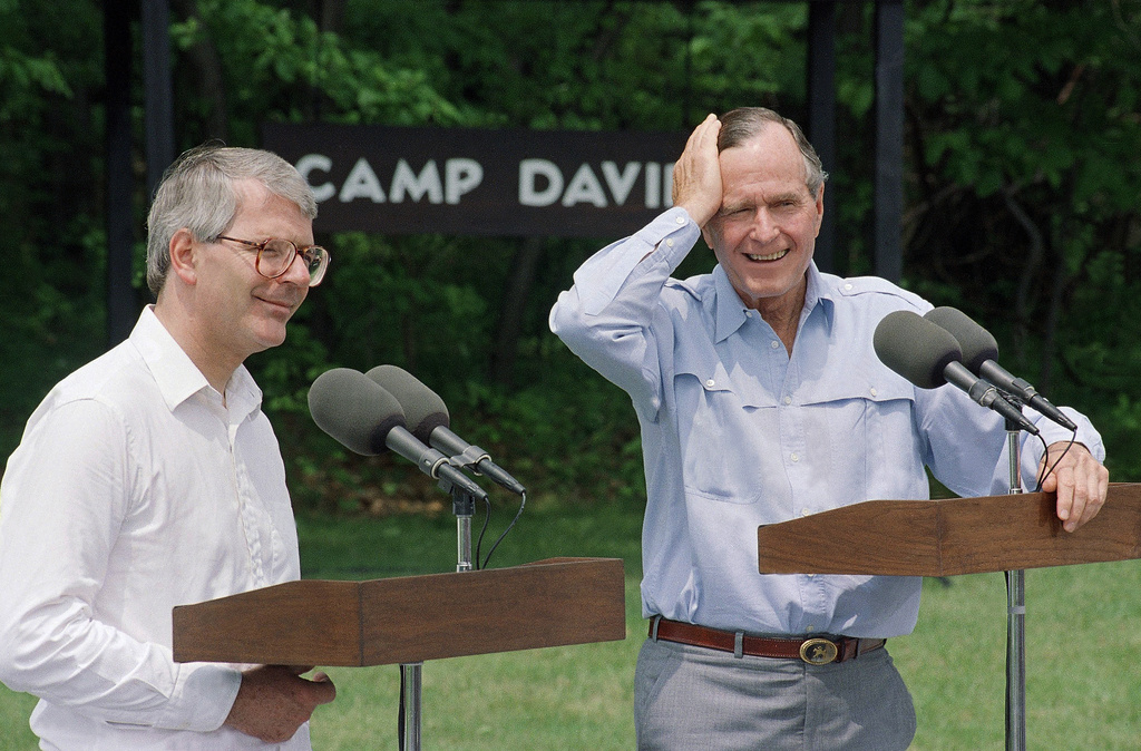 FILE - President George H.W. Bush and British Prime Minister John Major hold a news conference at Camp David, Md., June 7, 1992, following two days of talks. Topics included the Earth Summit in Rio de Janeiro which both leaders will attend later this week. (AP Photo/Dennis Cook, FILE)