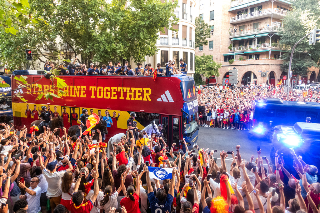 Players from Spain's national soccer team celebrate atop a bus as it travels through crowded streets in Madrid, Monday, July 20, 2026, after Spain defeated Argentina in the World Cup final in East Rutherford, N.J., near New York. (César Vallejo/Europa Press via AP)