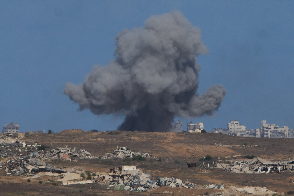 Smoke billows over Gaza Strip following an Israeli bombardment, as seen from southern Israel, Sunday, Oct. 5, 2025. (AP Photo/Ariel Schalit)