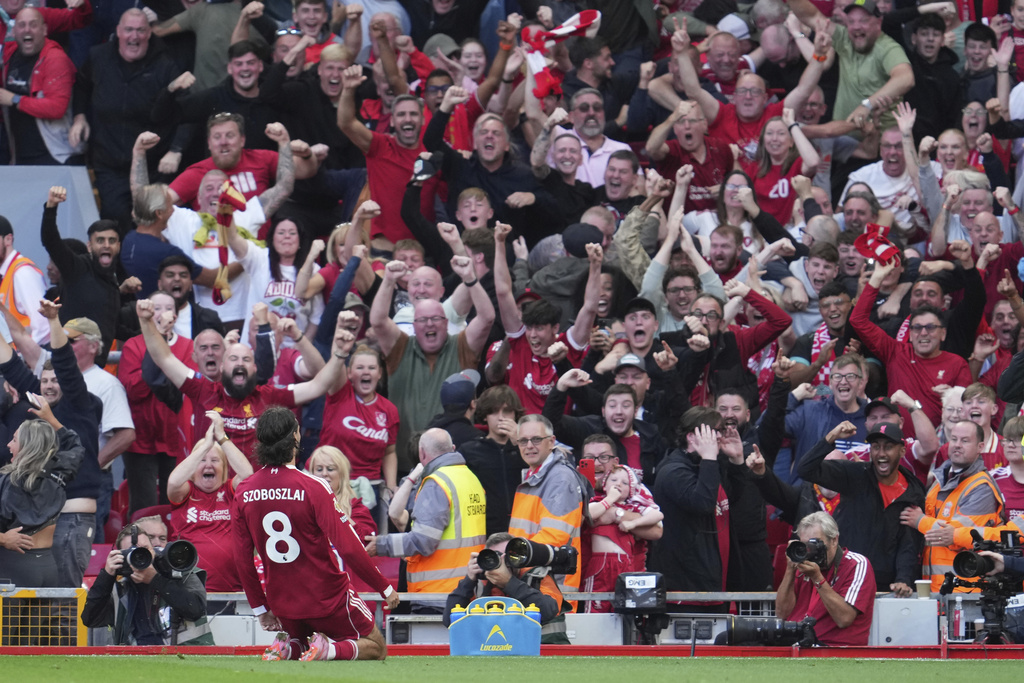 Liverpool's Dominik Szoboszlai celebrates after scoring his sides first goal during the English Premier League soccer match between FC Liverpool and FC Arsenal in Liverpool, England, Sunday, Aug. 31, 2025. (AP Photo/Jon Super)