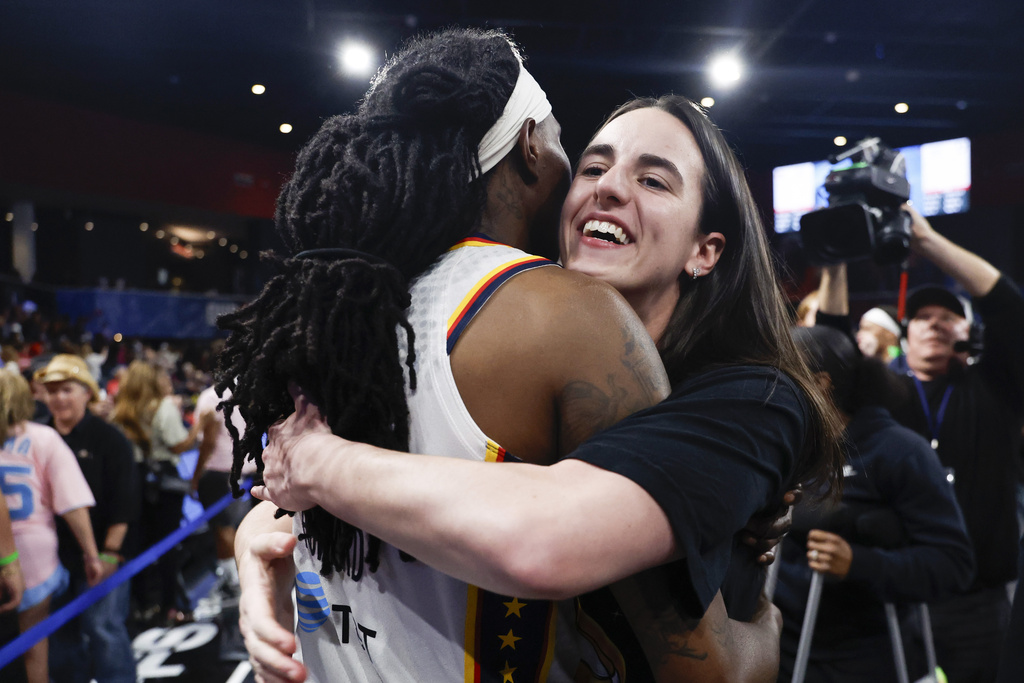 Indiana Fever guard Caitlin Clark, right, celebrates with forward Natasha Howard, left, after their team defeated the Atlanta Dream in Game 3 in the first round of the WNBA basketball playoffs, Thursday, Sept. 18, 2025, in Atlanta. (AP Photo/Butch Dill)