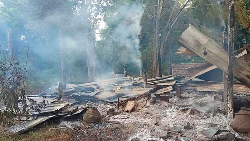 FILE - Smoke rises from debris and corrugated roofing of a school structure that was burned to the ground in Taung Myint village in the Magway region of Myanmar on Sunday, Oct. 16, 2022. (AP Photo, File)