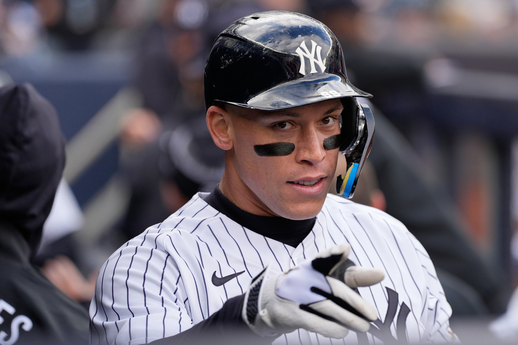 New York Yankees' Aaron Judge reacts in the dugout after hitting a two-run homer during the first inning of a baseball game against the Kansas City Royals, Sunday, April 19, 2026, in New York. (AP Photo/Seth Wenig)