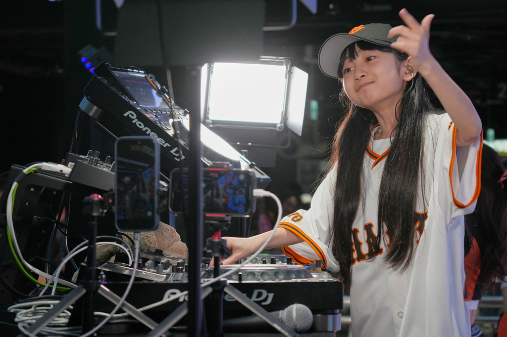Nine-year-old DJ Rinoka performs at Tokyo Dome before a Yomiuri Giants baseball game on May 24, 2026, in Tokyo. (AP Photo/Eugene Hoshiko)