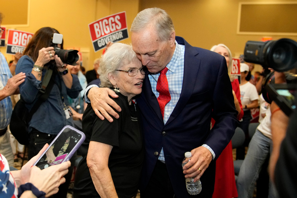 Rep. Andy Biggs, right, R-Ariz., who is running in the primary for Arizona governor, hugs a supporter at a campaign event, Friday, July 17, 2026, in Gilbert, Ariz. (AP Photo/Ross D. Franklin)