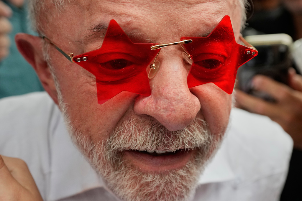 President Luiz Inacio Lula da Silva, who is seeking reelection, wears glasses given to him by a supporter after voting in the presidential runoff in Sao Bernardo do Campo, Brazil, Sunday, Oct. 25, 2026. (AP Photo/Natacha Pisarenko)