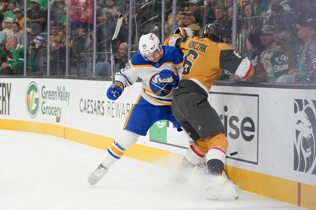 Buffalo Sabres center Tyson Kozak (48) collides with Vegas Golden Knights defenseman Kaedan Korczak (6) during the first period of an NHL hockey game Tuesday, March 17, 2026, in Las Vegas. (AP Photo/Candice Ward)