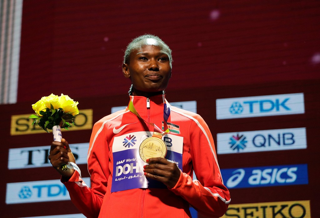 FILE - Kenya's Ruth Chepngetich poses with her gold medal during the medal ceremony for the women's marathon at the World Athletics Championships in Doha, Qatar, Sept. 28, 2019. (AP Photo/Nariman El-Mofty, file)