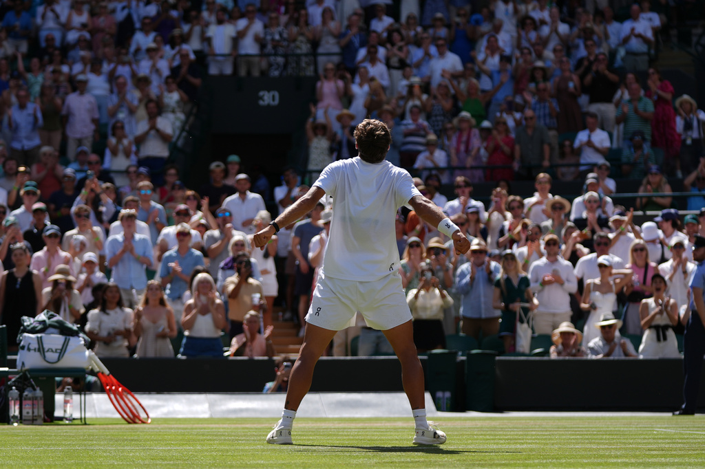 Flavio Cobolli of Italy celebrates winning against Alex de Minaur of Australia in their fourth round men's singles match at the Wimbledon Tennis Championships in London, Monday, July 6, 2026. (AP Photo/Maja Smiejkowska)