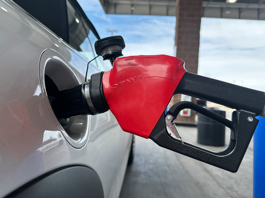 A motorist fills up the tank of a vehicle at a Coscto gasoline station Thursday, March 12, 2026, in east Denver. (AP Photo/David Zalubowski)