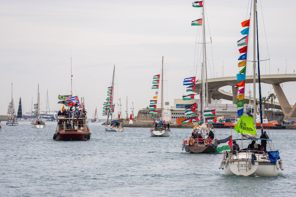 Boats carrying activists and humanitarian aid for Palestinians in Gaza reposition in the port during a symbolic send-off as part of the Global Sumud Flotilla, in Barcelona, Spain, Sunday, April 12, 2026. (AP Photo/Joan Mateu Parra)