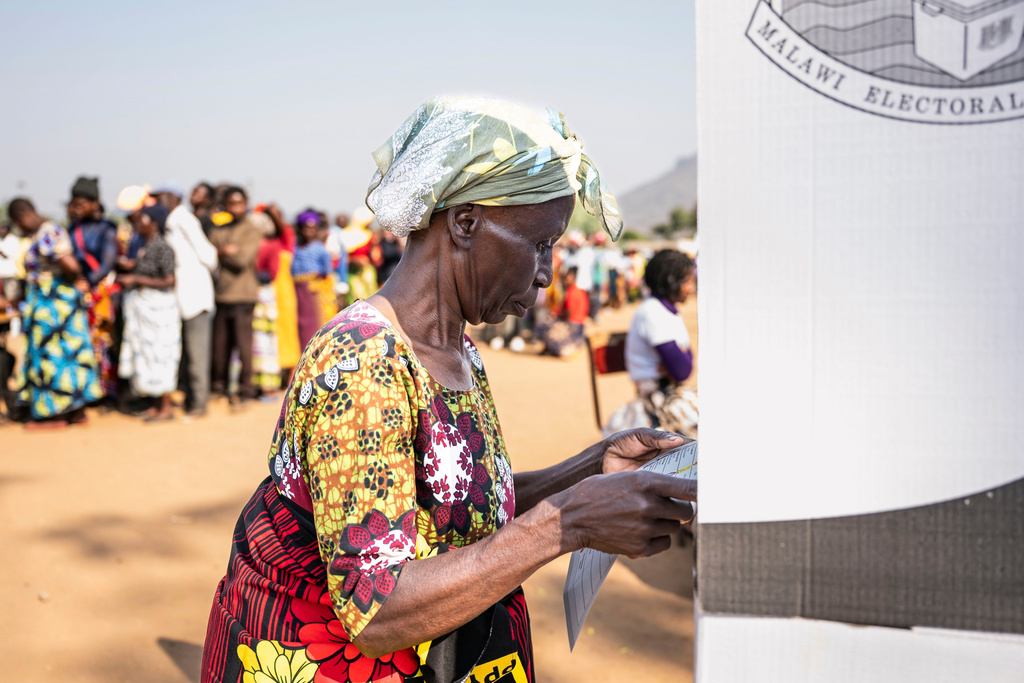 A woman prepares to casts her vote in Blantyre, Malawi, Tuesday, Sept. 16, 2025. (AP Photo/Thoko Chikondi)