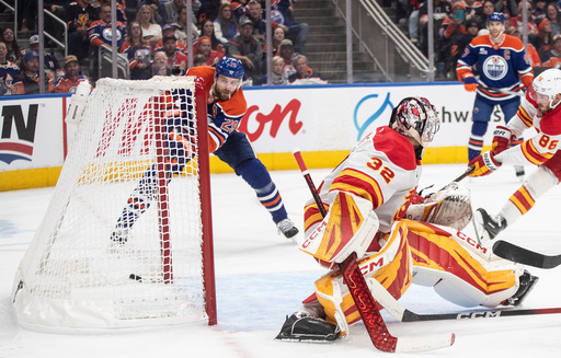 Edmonton Oilers' Leon Draisaitl (29) scores his 400th career goal against Calgary Flames goalie Dustin Wolf (32) during second period NHL action, in Edmonton on Wednesday, Oct. 8, 2025. (Jason Franson/The Canadian Press via AP) Edmonton Oilers' Leon Draisaitl (29) scores his 400th career goal against Calgary Flames goalie Dustin Wolf (32) during second period NHL action, in Edmonton on Wednesday, Oct. 8, 2025. (Jason Franson/The Canadian Press via AP)