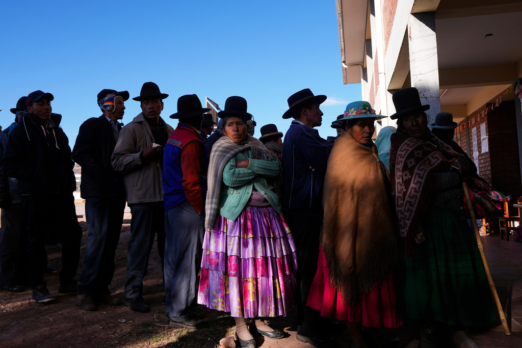 FILE - Voters stand in line at a polling station during general elections in Jesus de Machaca, Bolivia, Aug. 17, 2025. (AP Photo/Juan Karita, File)