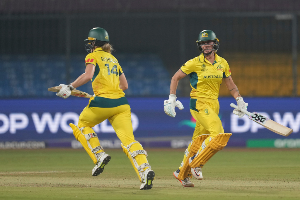 Australia's Ashleigh Gardner , right, and Australia's Annabel Sutherland run between the wickets during the ICC Women's Cricket World Cup cricket match between England and Australia at Holkar Cricket Stadium in Indore, India, Wednesday, Oct. 22, 2025. (AP Photo/Rafiq Maqbool)