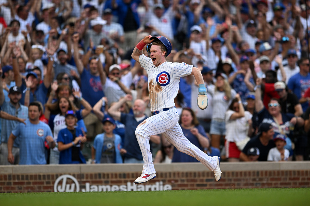 Chicago Cubs' Pete Crow-Armstrong celebrates while scoring the winning run on a throwing error by Toronto Blue Jays catcher Brandon Valenzuela during the eleventh inning of a baseball game in Chicago, Thursday, Aug. 6, 2026. (AP Photo/Paul Beaty)