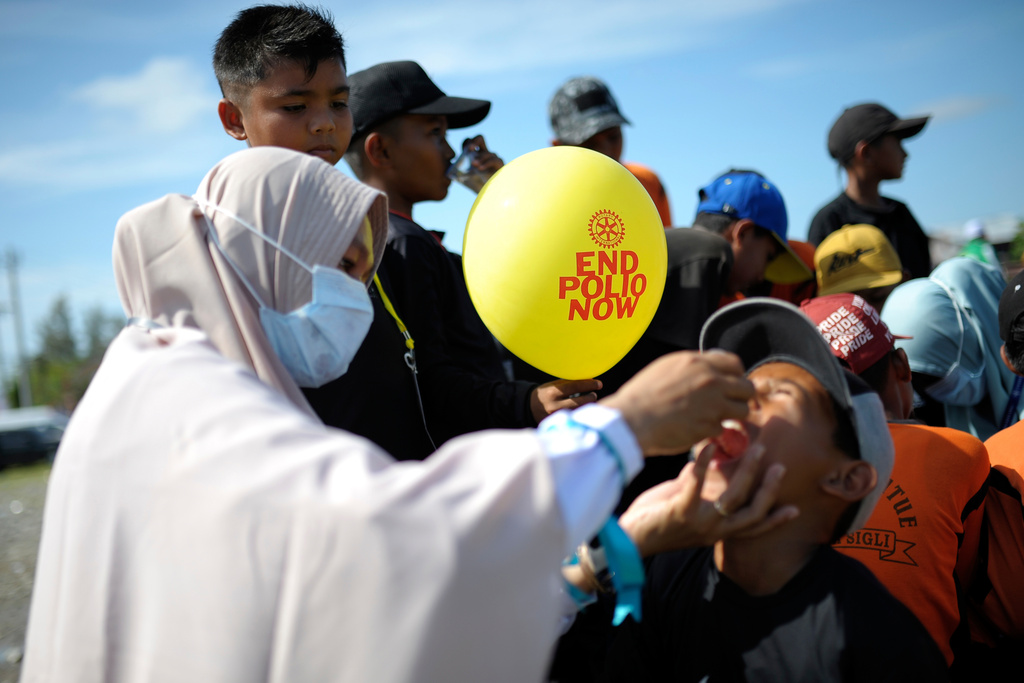 FILE - A medical worker gives a vaccine to a boy during a polio immunization campaign at Sigli Town Square in Pidie, Aceh province, Indonesia, Nov. 28, 2022. (AP Photo/Riska Munawarah, File)