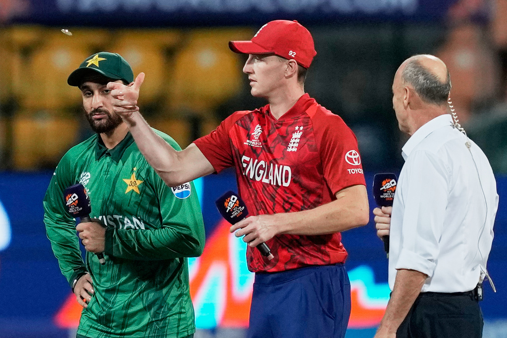 England's captain Harry Brook, centre, tosses the coin as Pakistan's captain Salman Ali Agha looks on before the start of the T20 World Cup cricket match between England and Pakistan in Pallekele, Sri Lanka, Tuesday, Feb. 24, 2026. (AP Photo/Eranga Jayawardena)